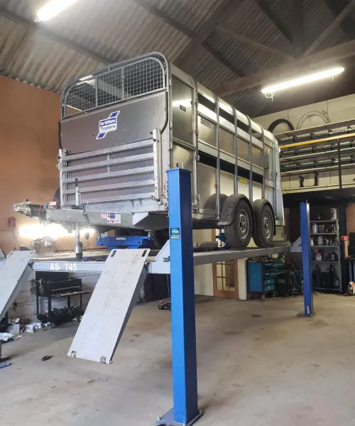 Ifor Williams livestock trailer on four post repair lift