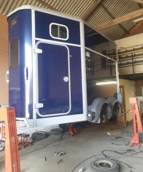 Blue Ifor Williams horsebox being serviced